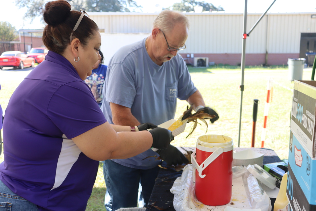 man and woman dipping roasted corn in butter 