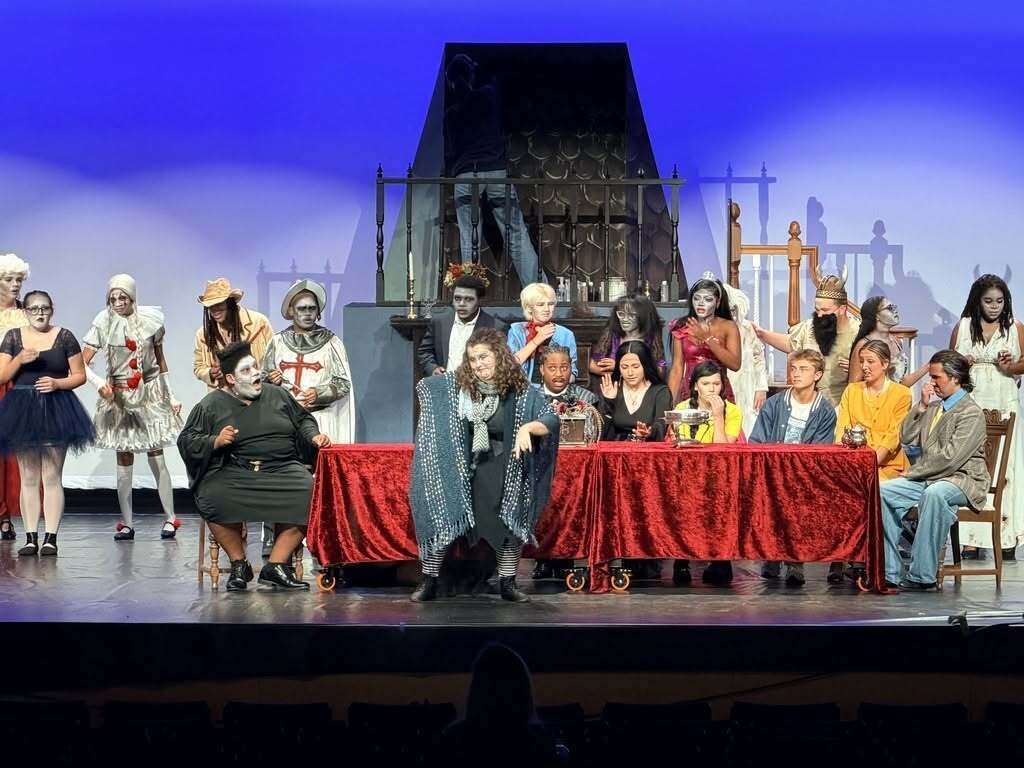 performers on stage for the adams family