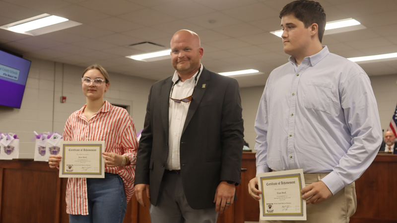Decatur County Schools staff, students, and community members participate in an awards and recognition ceremony, receiving certificates, plaques, and honors.