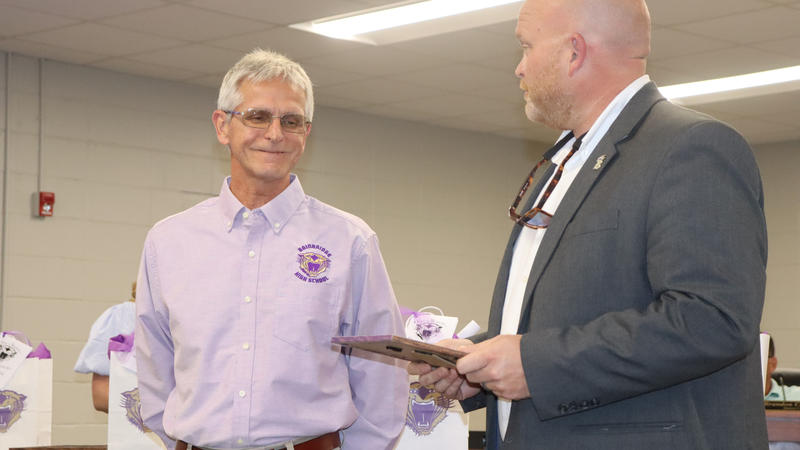 Decatur County Schools staff, students, and community members participate in an awards and recognition ceremony, receiving certificates, plaques, and honors.