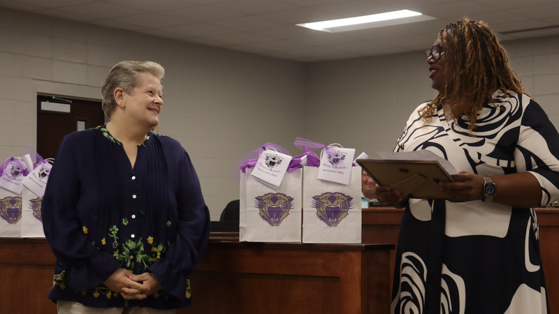 Decatur County Schools staff, students, and community members participate in an awards and recognition ceremony, receiving certificates, plaques, and honors.
