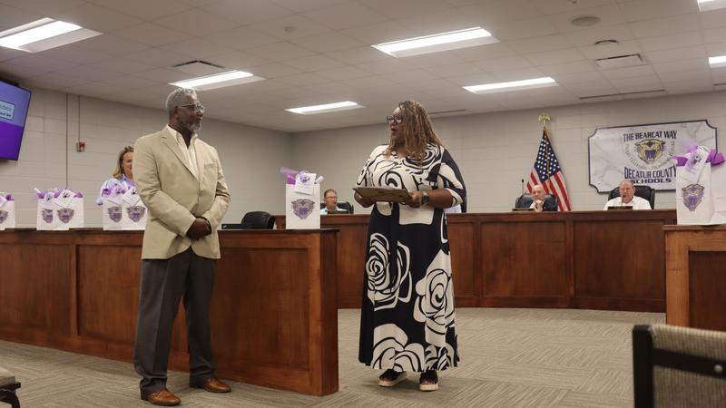 Decatur County Schools staff, students, and community members participate in an awards and recognition ceremony, receiving certificates, plaques, and honors.