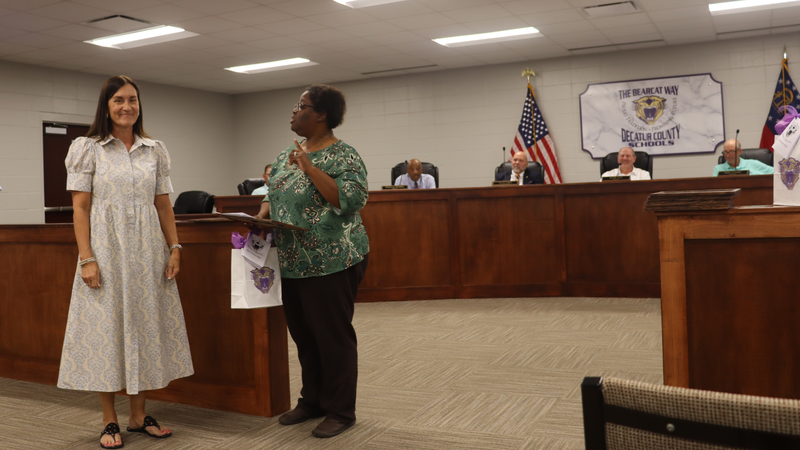 Decatur County Schools staff, students, and community members participate in an awards and recognition ceremony, receiving certificates, plaques, and honors.