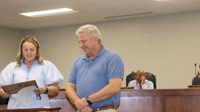 Decatur County Schools staff, students, and community members participate in an awards and recognition ceremony, receiving certificates, plaques, and honors.