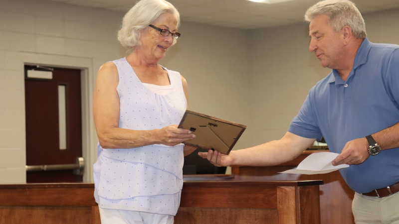 Decatur County Schools staff, students, and community members participate in an awards and recognition ceremony, receiving certificates, plaques, and honors.