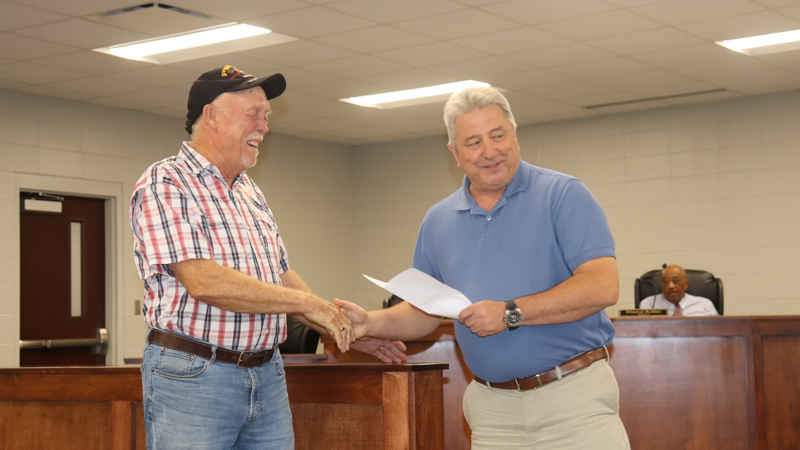 Decatur County Schools staff, students, and community members participate in an awards and recognition ceremony, receiving certificates, plaques, and honors.