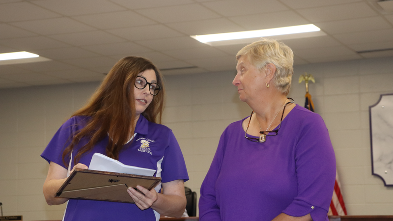 Decatur County Schools staff, students, and community members participate in an awards and recognition ceremony, receiving certificates, plaques, and honors.