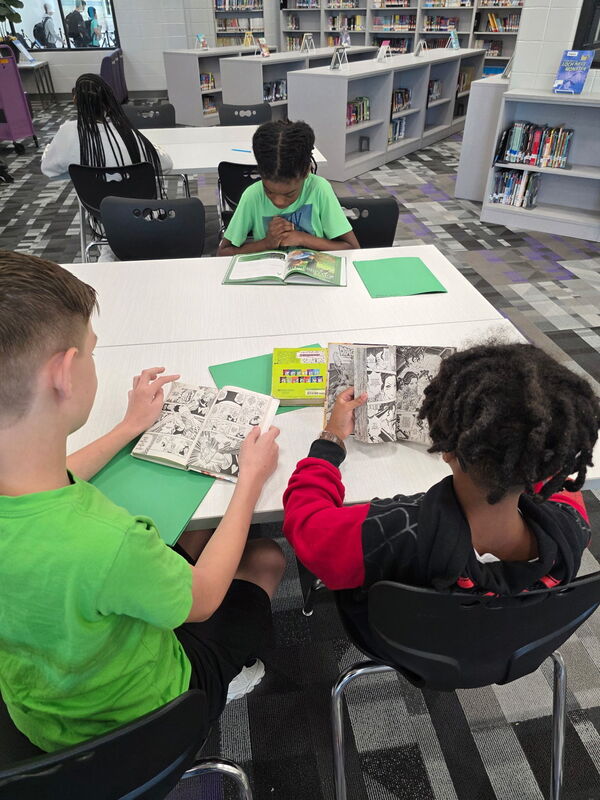 6th Grade students reading their books.