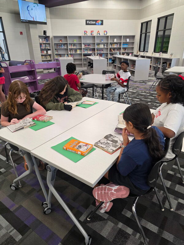 6th grade students reading books. 