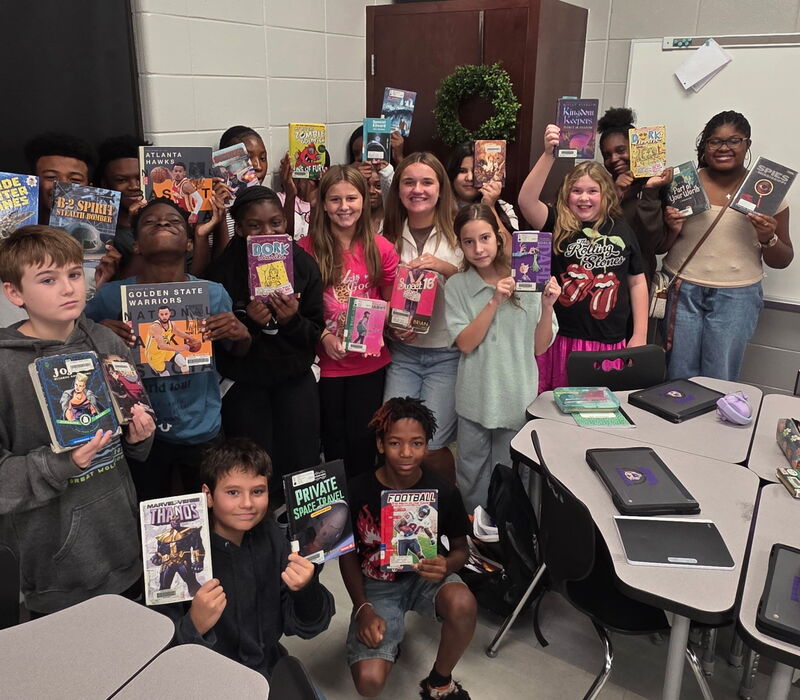 6th grade students with their books.