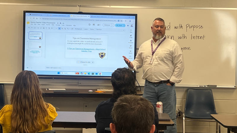 An educator leads a professional development session on classroom management strategies using an interactive presentation.