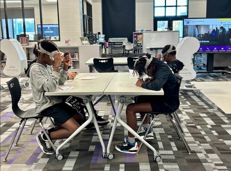 Students working together using VR headsets.