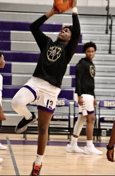 Students about to score a basketball goal