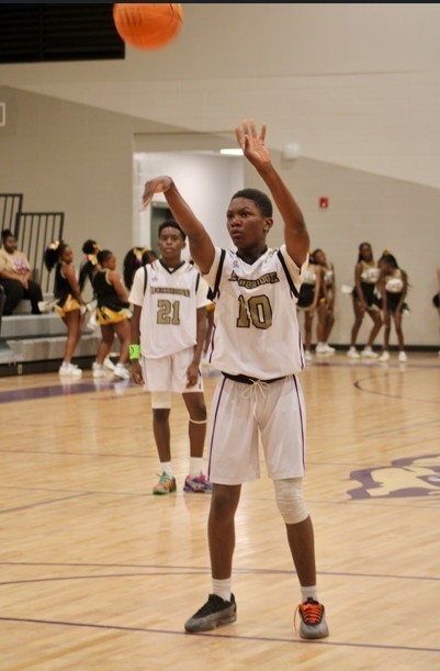 Middle School student shooting the basketball