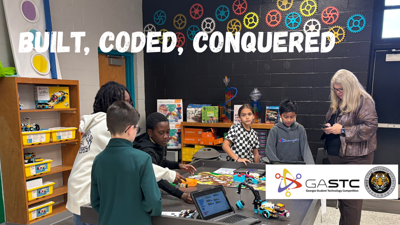 Built, Coded, Conquered students demonstrate robotics projects to Ms Amy Zock, Director of Instructional and Innovative Technology during judging for GASTC school level competition at Hutto Elementary School