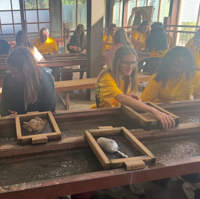 students mining for gold on the GA Studies Trip