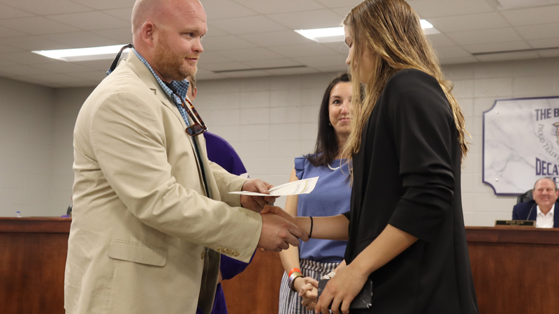 Student recognized by the Decatur County Schools Board of Education for athletic achievement during a board meeting