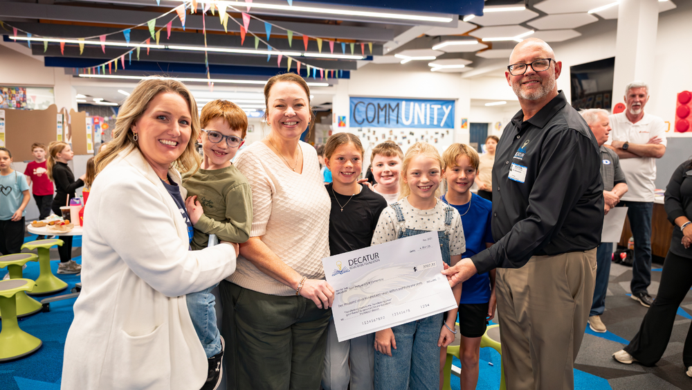 Photo of teachers and staff at Young elementary receiving a giant check for a grant award