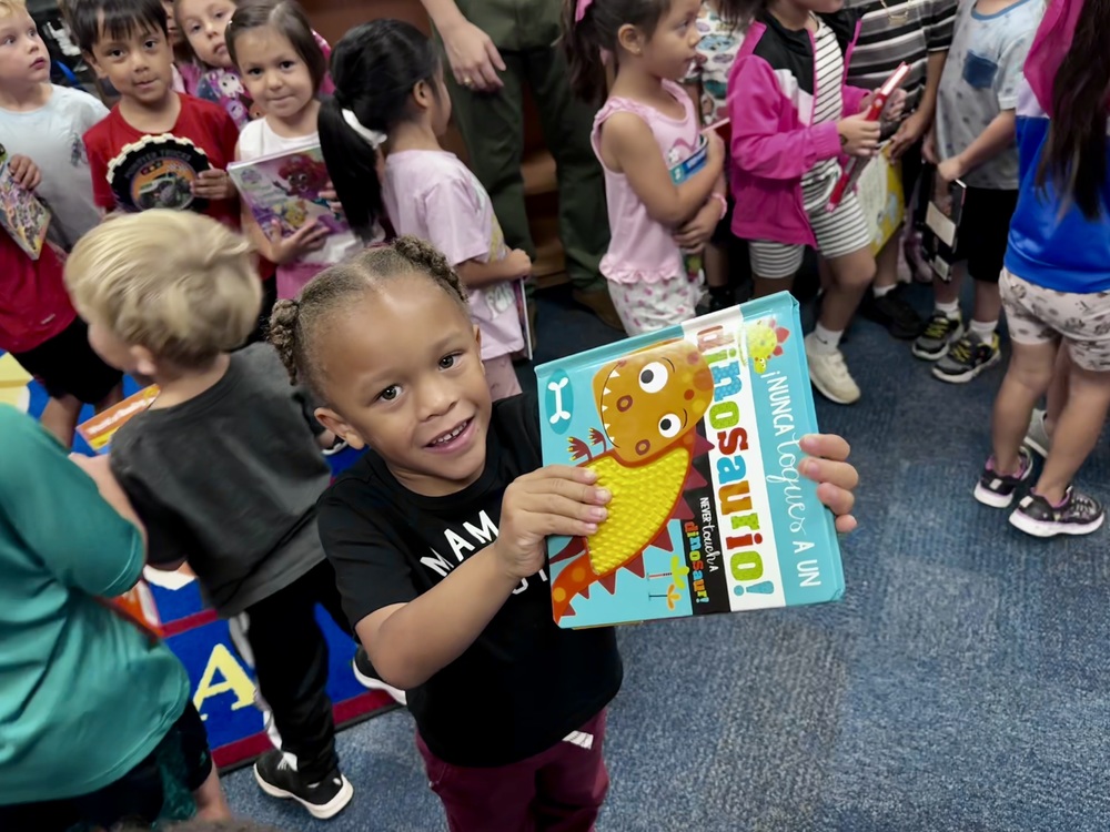 A child at Rann Elementary shows off his new book