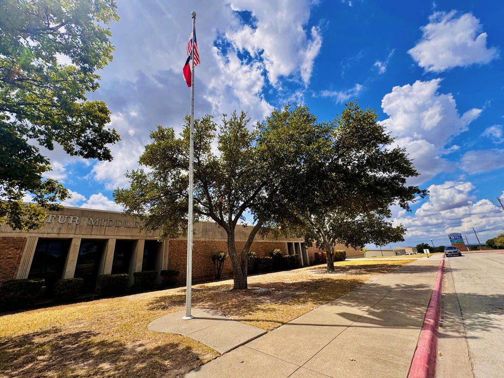 Photo of McCarroll Middle School on a bright and sunny day with beautiful clouds visible