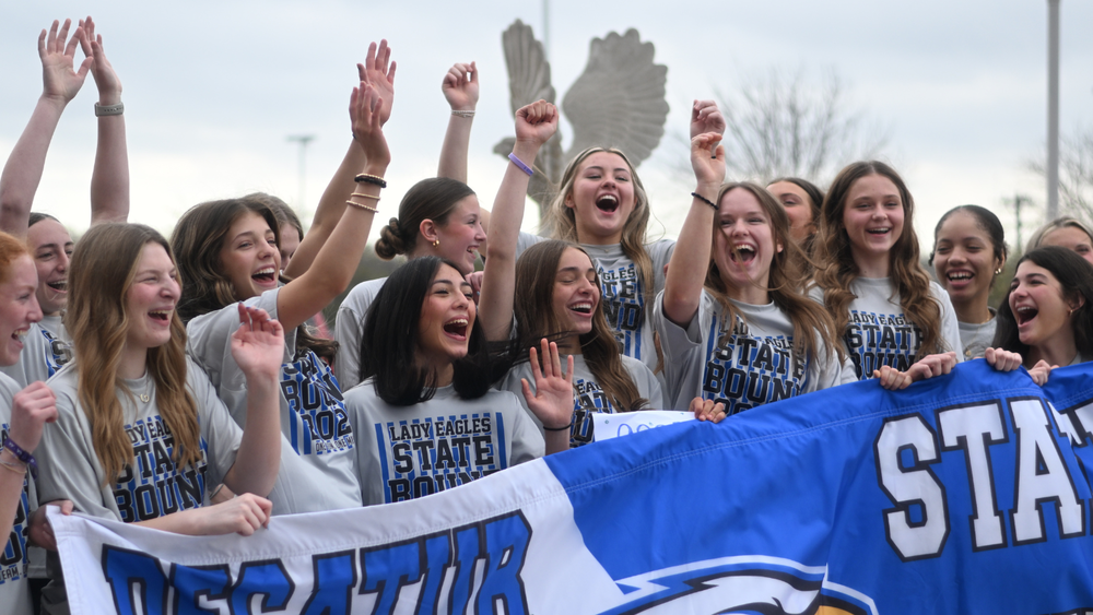 Photo of the team celebrating during their state sendoff at the high school