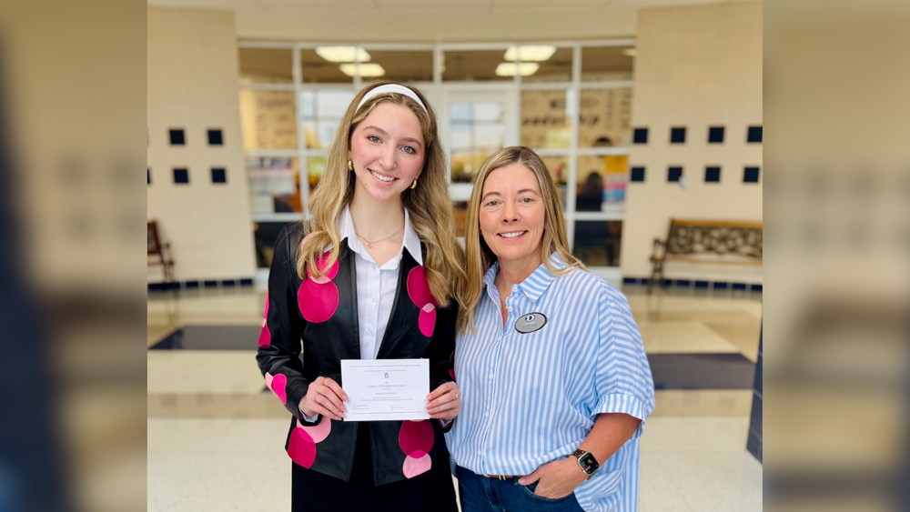 Photo of Maggie Ballou with her Commended Student certificate. She is pictured with High School Principal Tammy Allen.