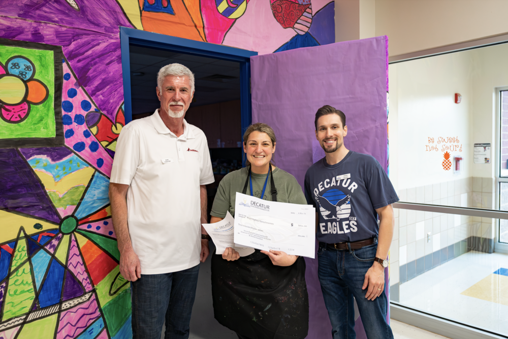 Photo of the art teacher receiving her grant