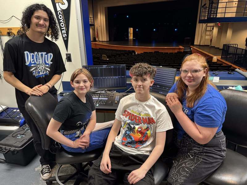 Theatre students pose for a photo after  installing the new light board 