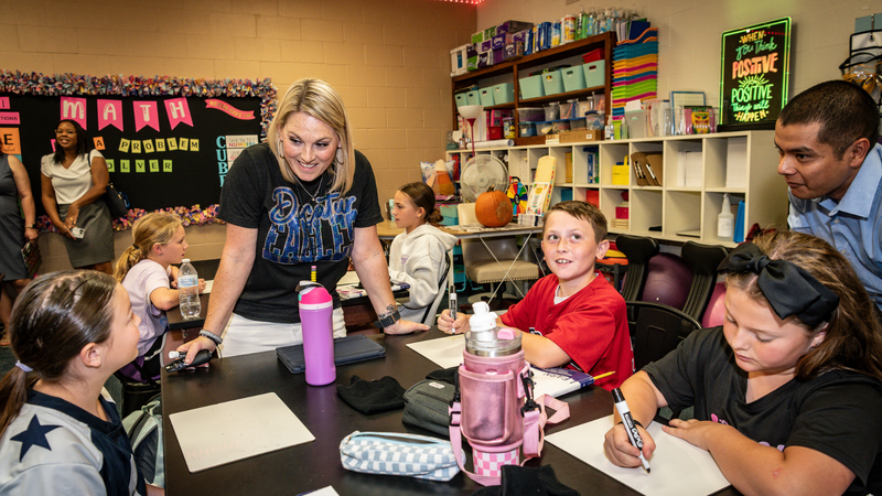 Photo Photo of Rann Teacher Tiffany Bearden in her classroom talking with  a group of students at their desks