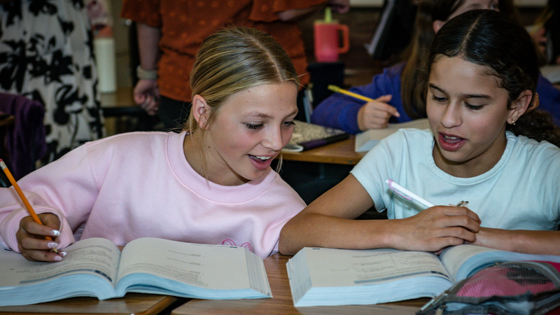 Photo of two students working on an assignment together