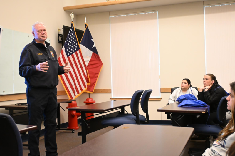 firefighter talking to students