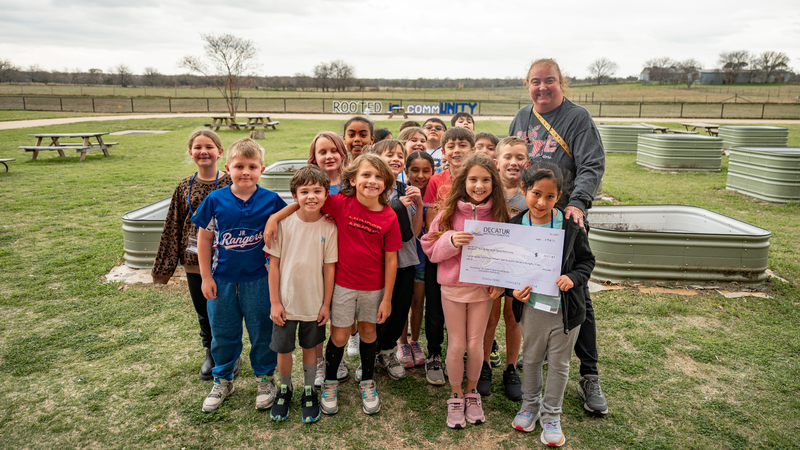 Tammy Rainey at Young Elementary is pictured with several students and her grant check
