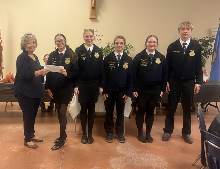 Accepting the contribution from the Women’s Committee.