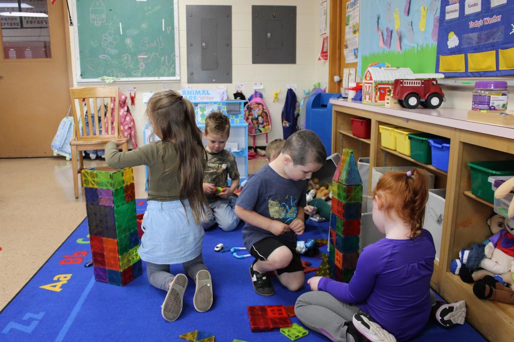 Preschoolers playing with toys in classroom