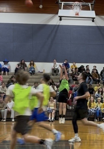 Middle School student shooting during staff vs. student basketball game