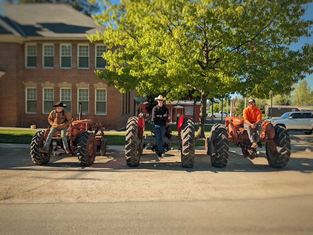 Homelink students finial week highlights - students sitting on tractors.