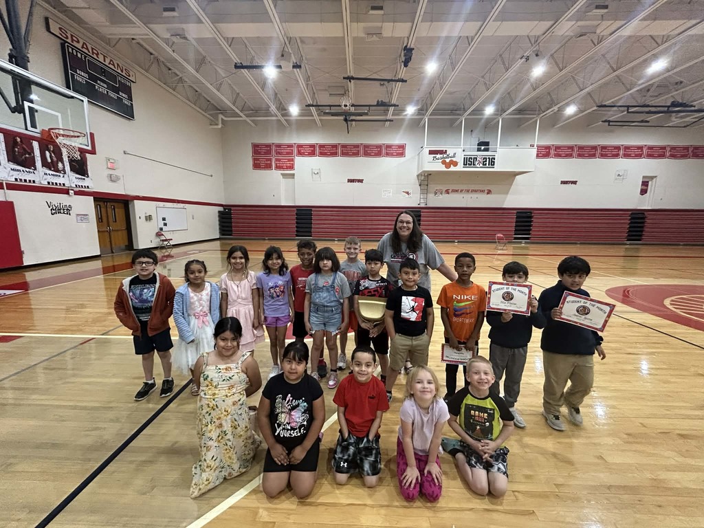 2nd grade class in gym with certificates