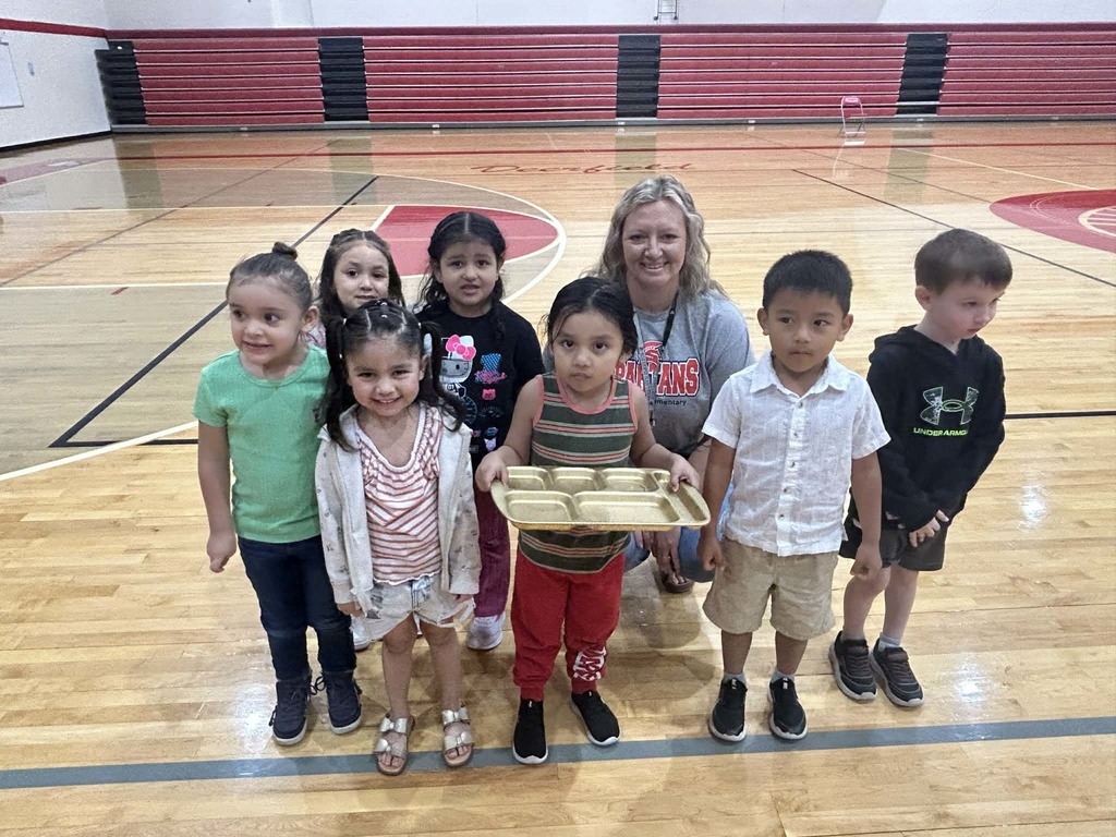 Pre K students in gym with golden tray
