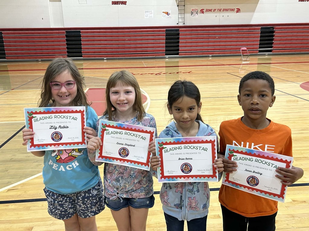 Elementary students with certificates in gym