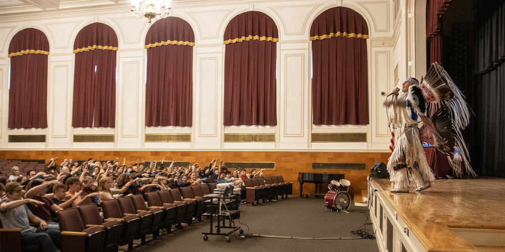 image of native american dancer and rapper with audience responding to him