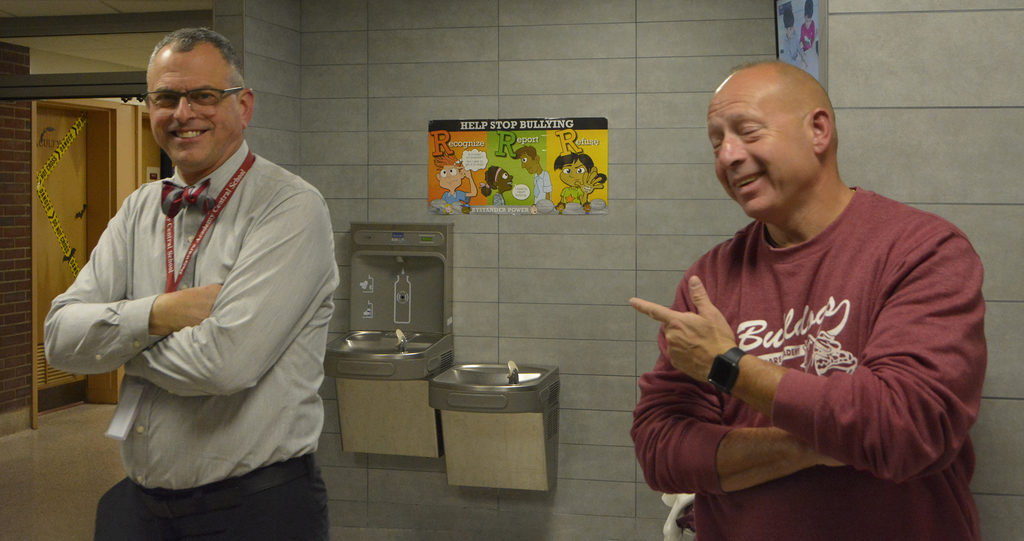 principal and schoiol resource officer laugh for camera