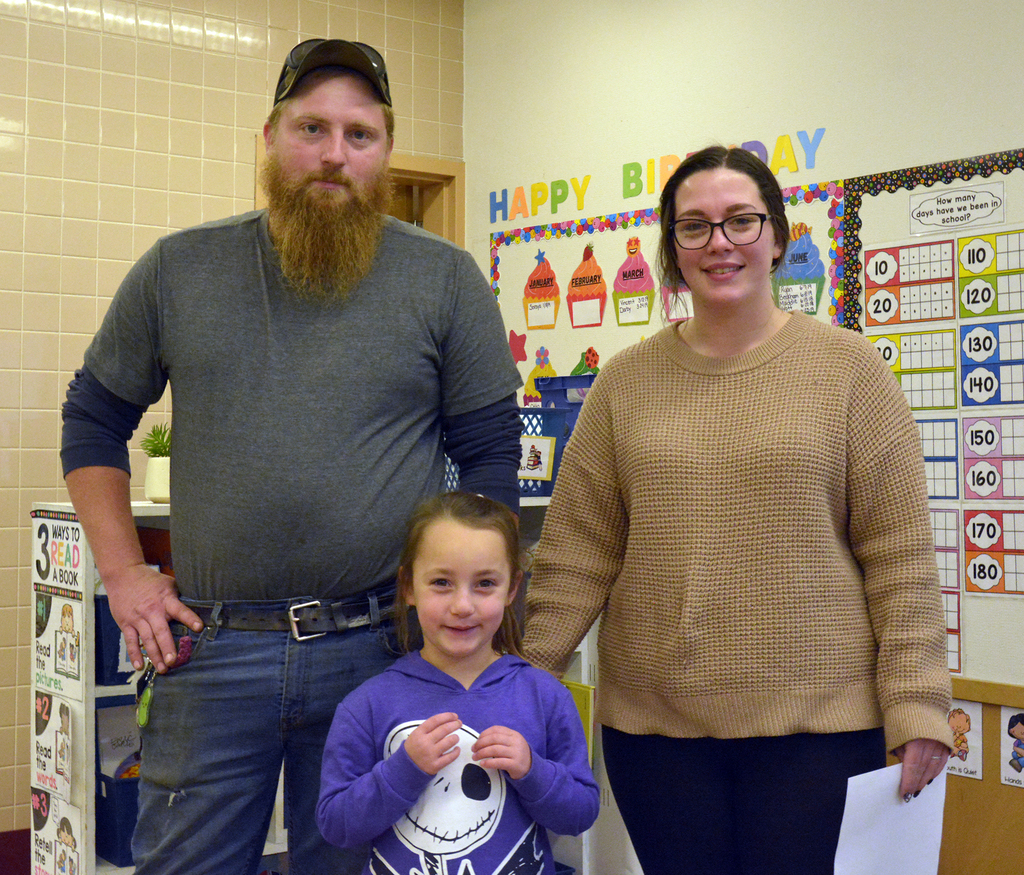 2 adults and a child smile