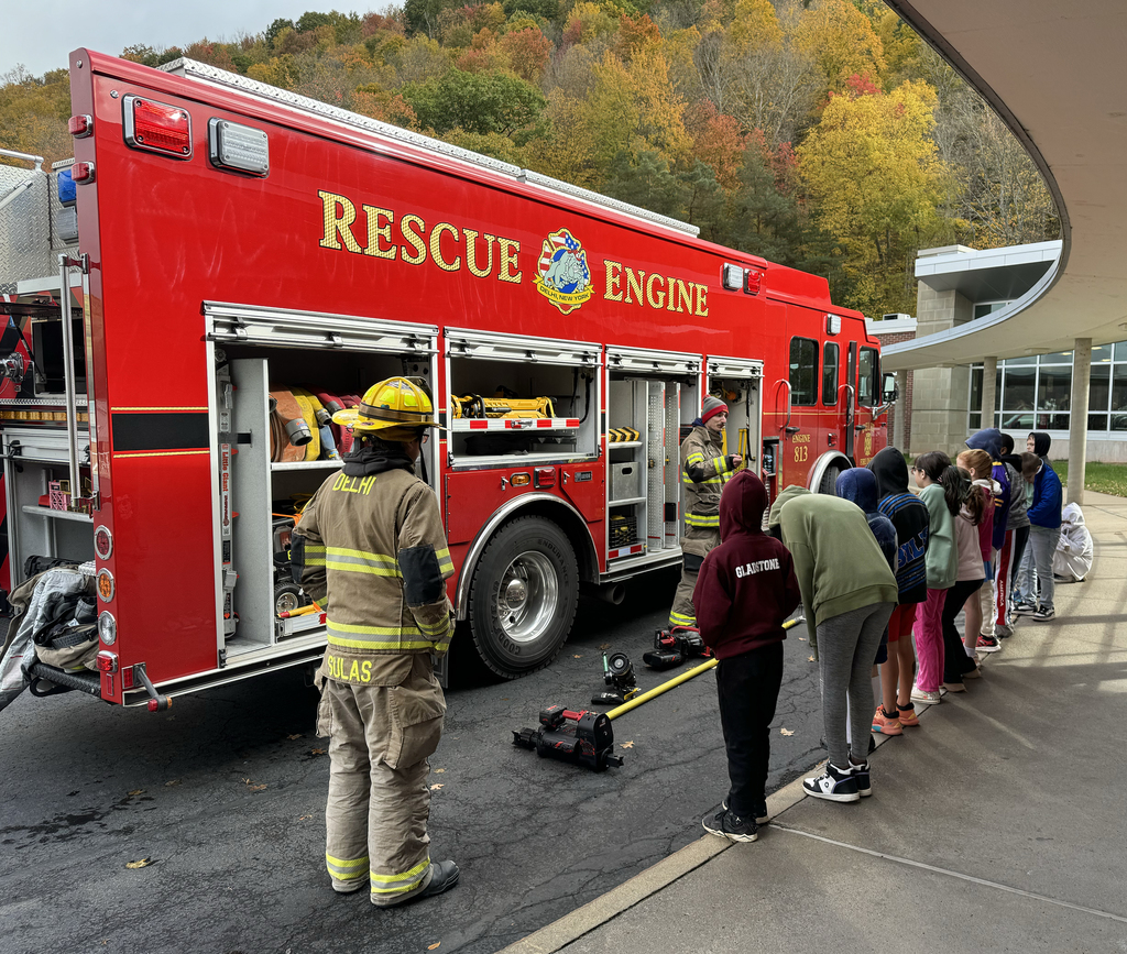 firefighters with fire truck speak to children i