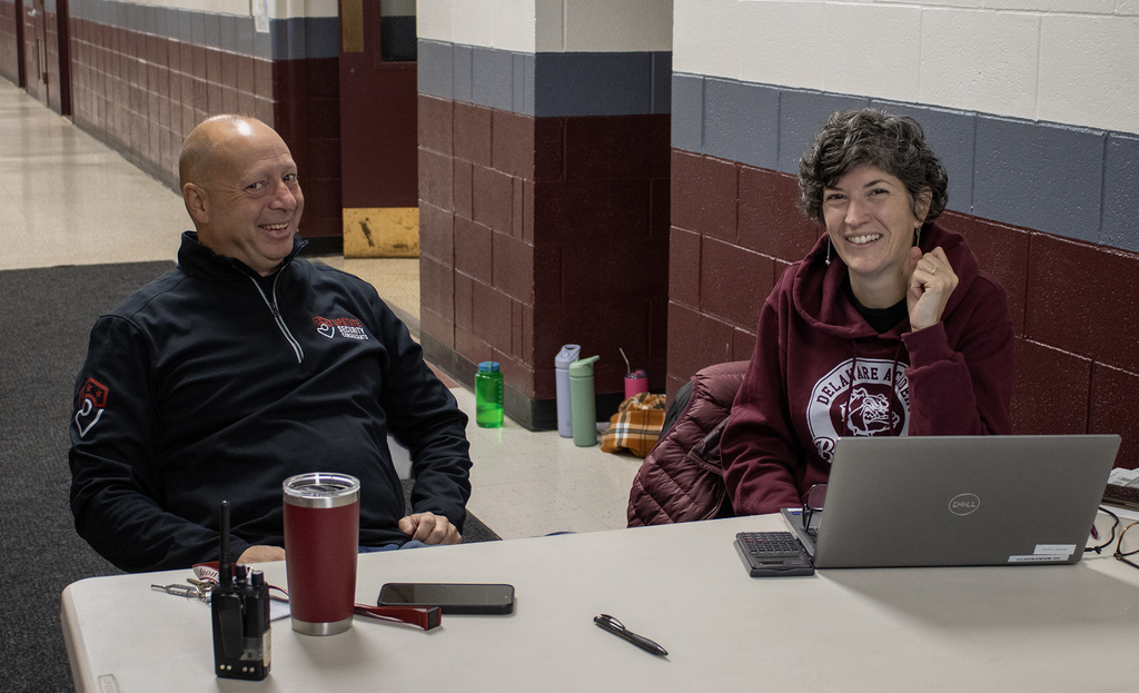 two adults smiling at table