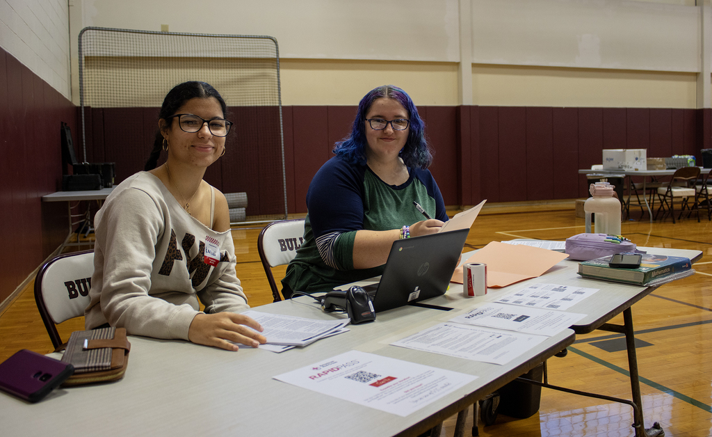 two students smiling at table
