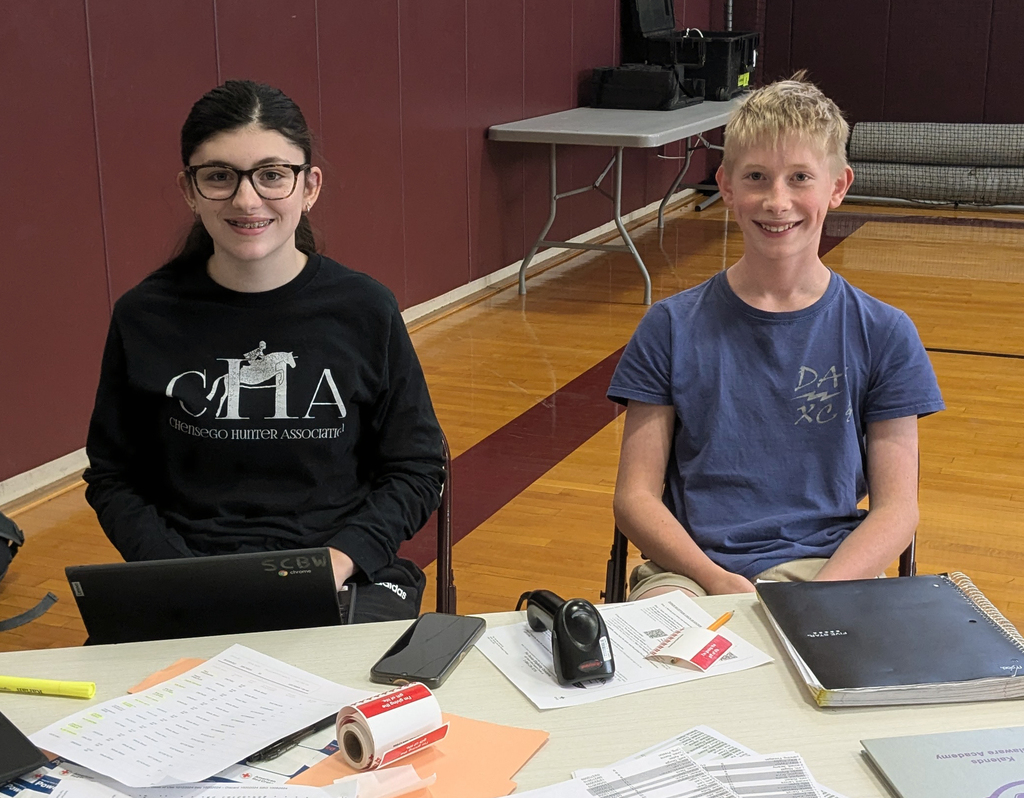 two students smiling at table
