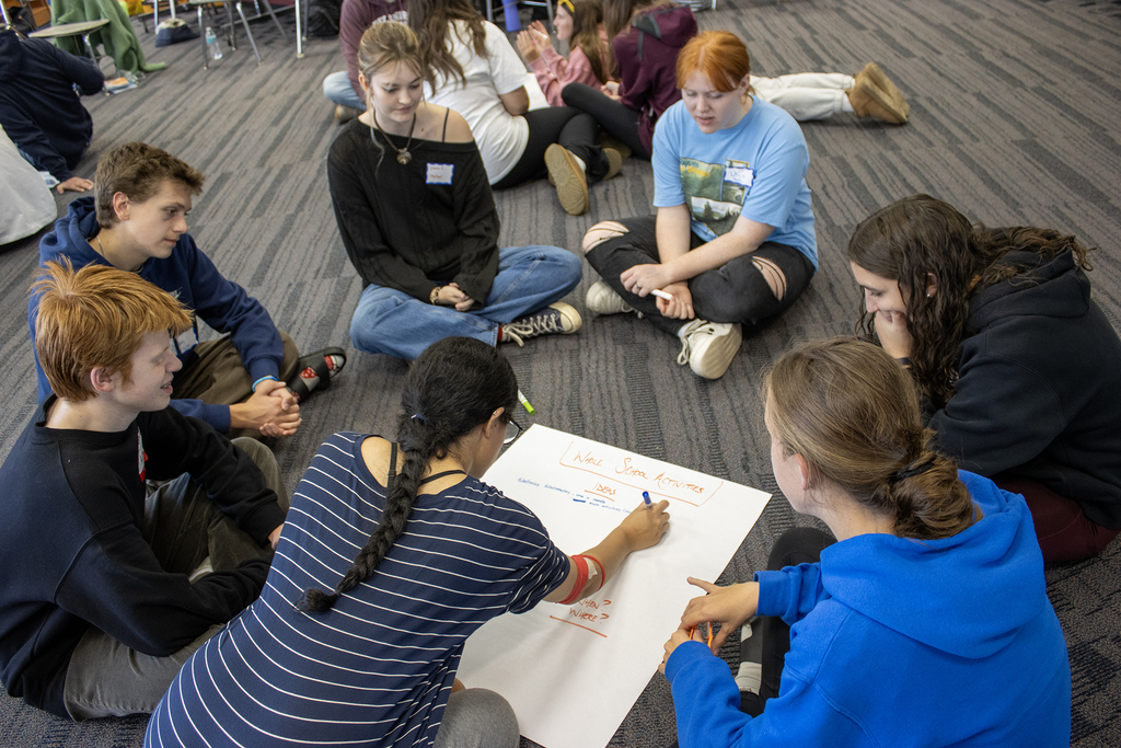 a group of students capture idea on a marker pad