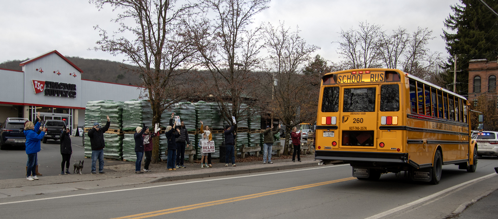 supporters cheer the bus downtown
