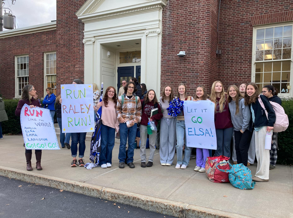 students gather in front of SK school