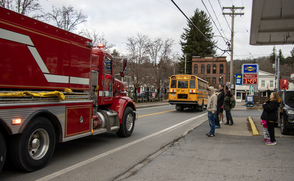 fire truck and school bus get cheered downtown
